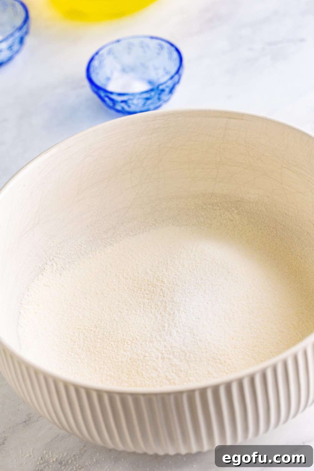 Finely ground sugar and flour sifted together in a bowl.