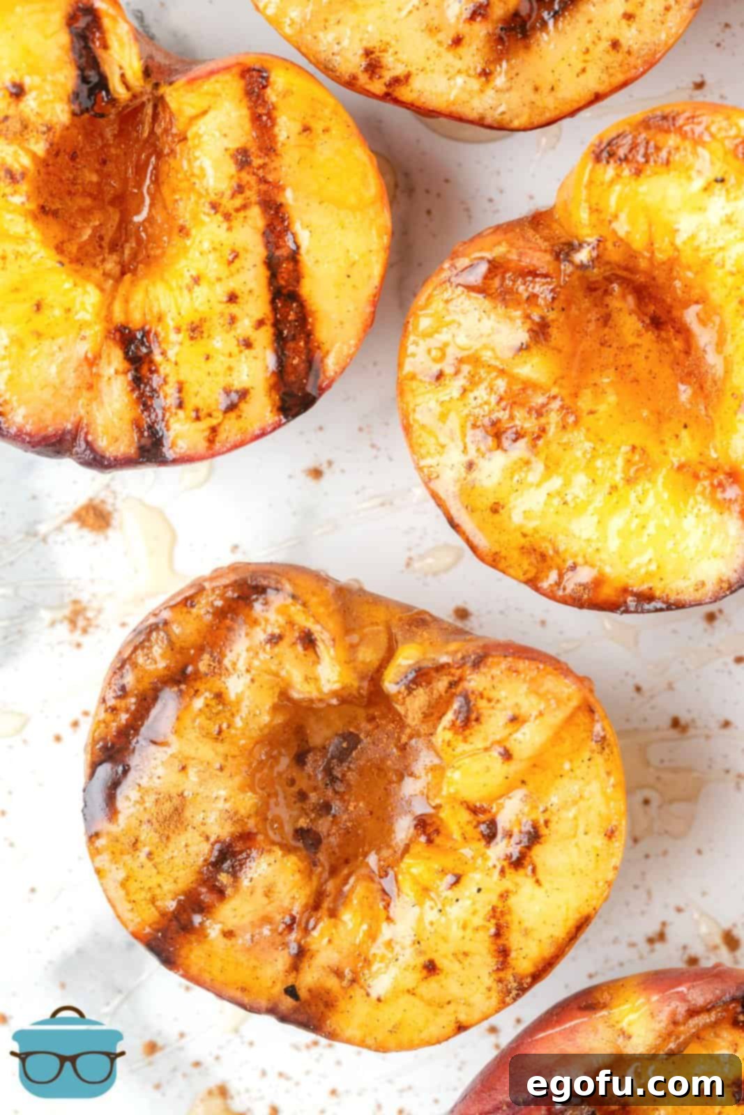 Close up of Grilled Peaches with cinnamon and honey showing grill marks, ready to be served.