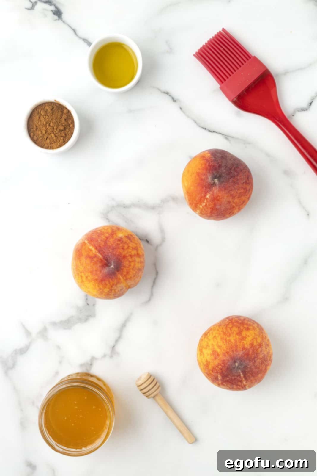 Ingredients needed: peaches, oil, cinnamon, honey and vanilla ice cream, arranged on a rustic surface.