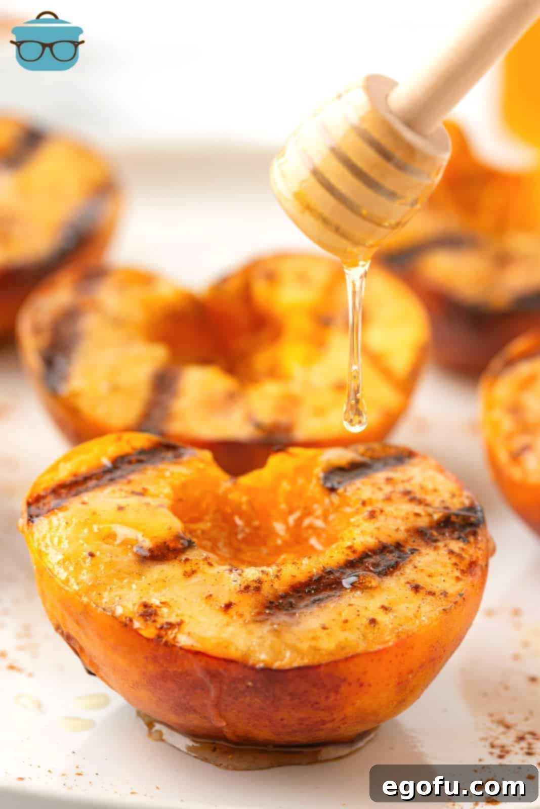 Honey being drizzled over freshly Grilled Peaches, ready for serving.