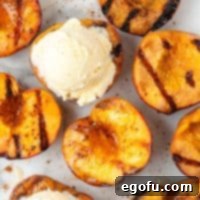 Square image of Grilled Peaches drizzled with honey and cinnamon, with one serving topped with a scoop of ice cream.