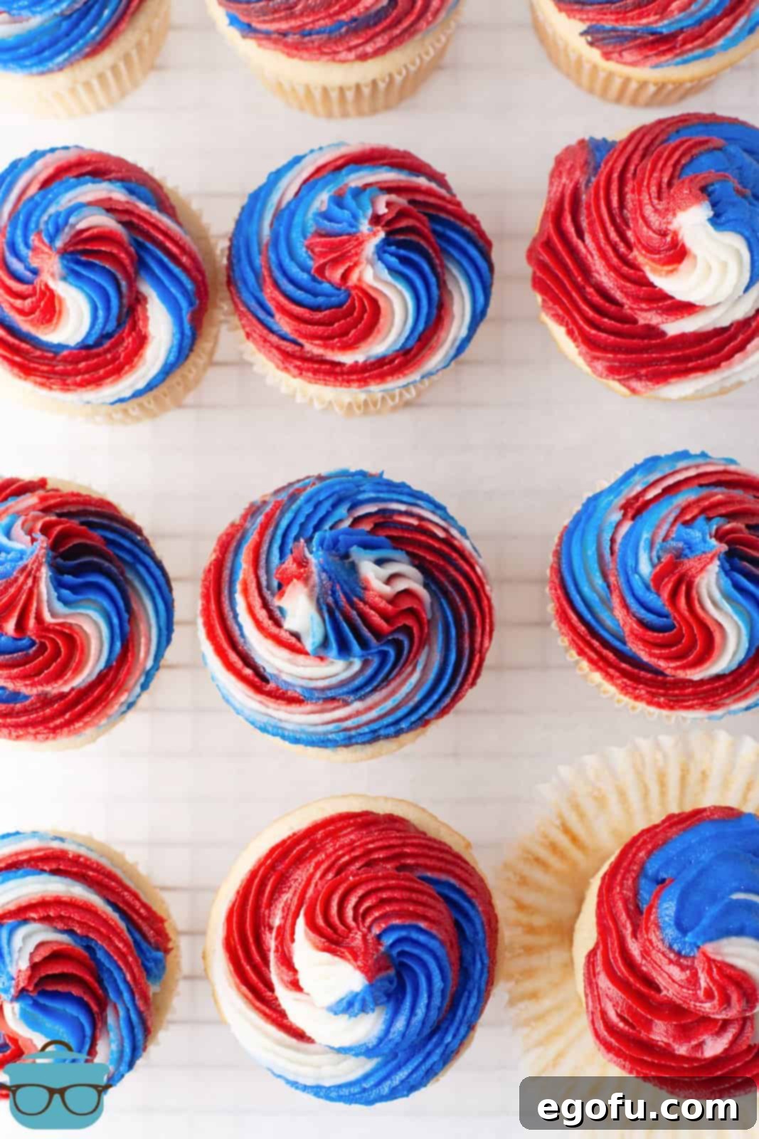 Overhead of 4th of July cupcakes on wire rack.
