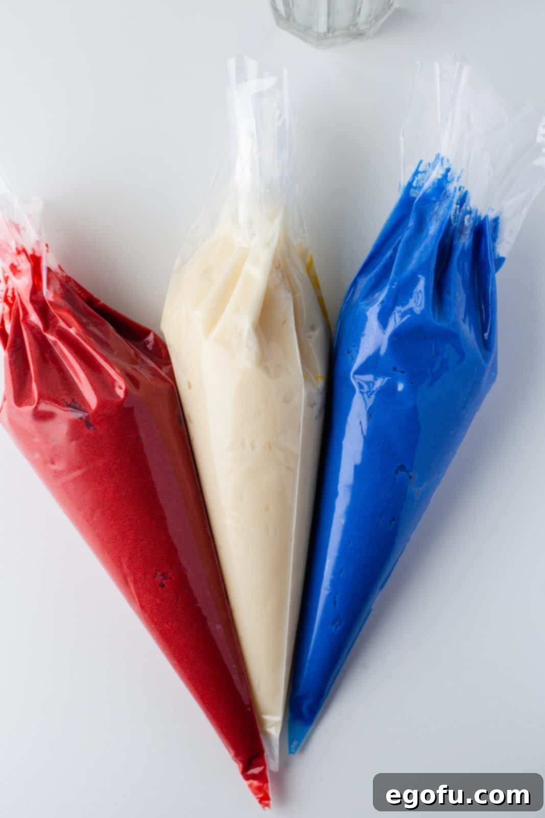 Frosting added to 3 separate piping bags.