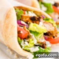 Square image close up of Chicken Gyros showing filling ingredients.