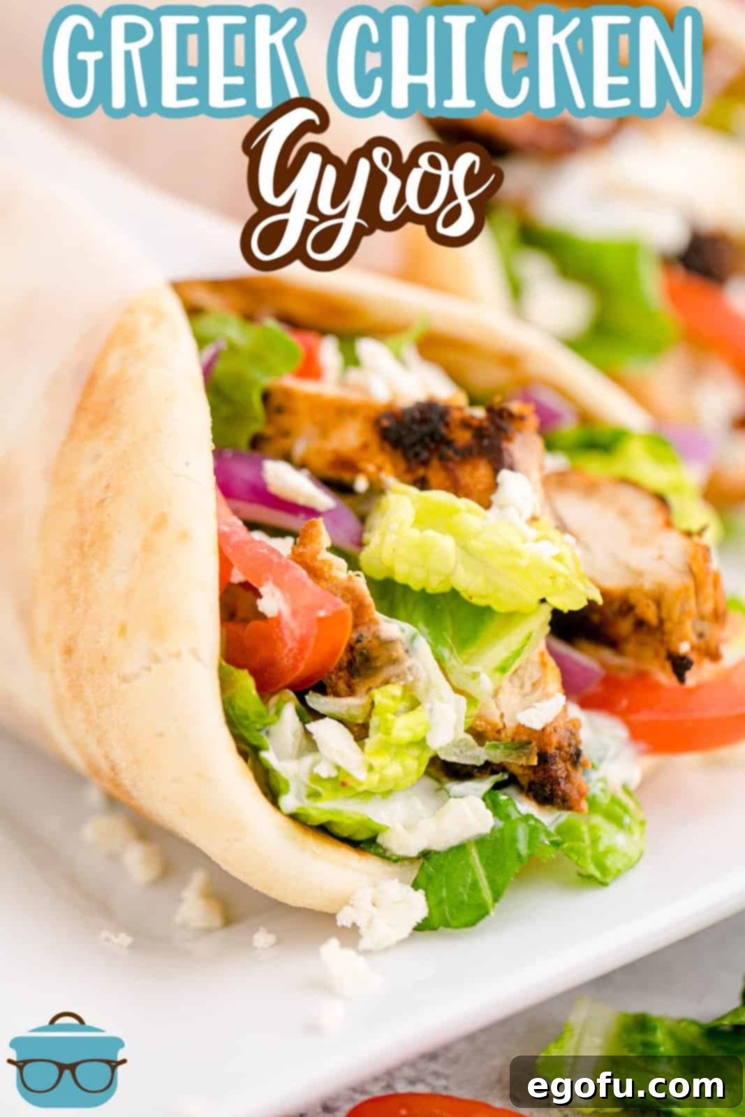 Close-up photo of a Greek Chicken Gyro with pita bread wrap on a round white plate, showcasing the vibrant filling.