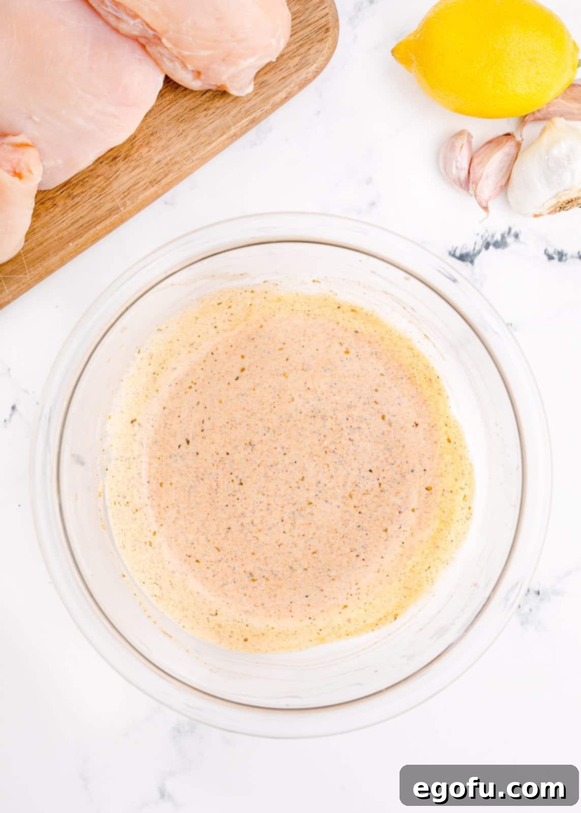 Marinade ingredients mixed up in a bowl, showing the creamy, spiced mixture.