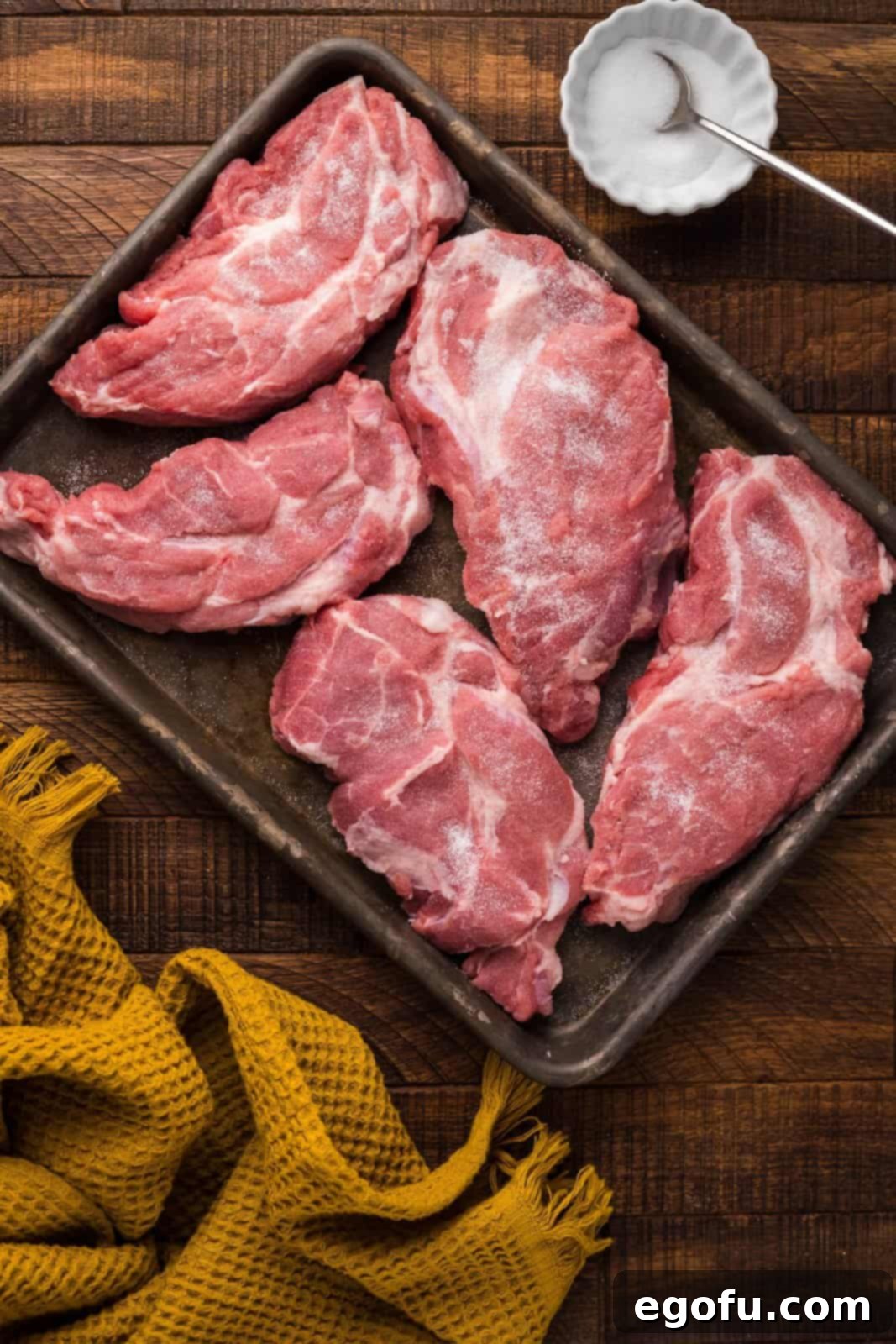 Pork steaks sprinkled with salt.