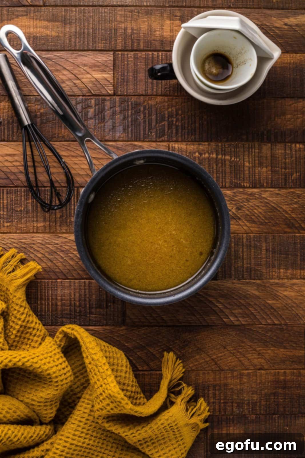 Apple cider vinegar, worcheshire sauce, olive oil, and garlic paste whisked together in saucepan.