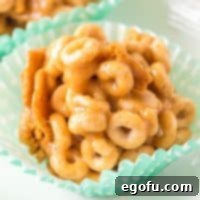 Square image close up of Peanut Butter Cheerio Balls in liners.