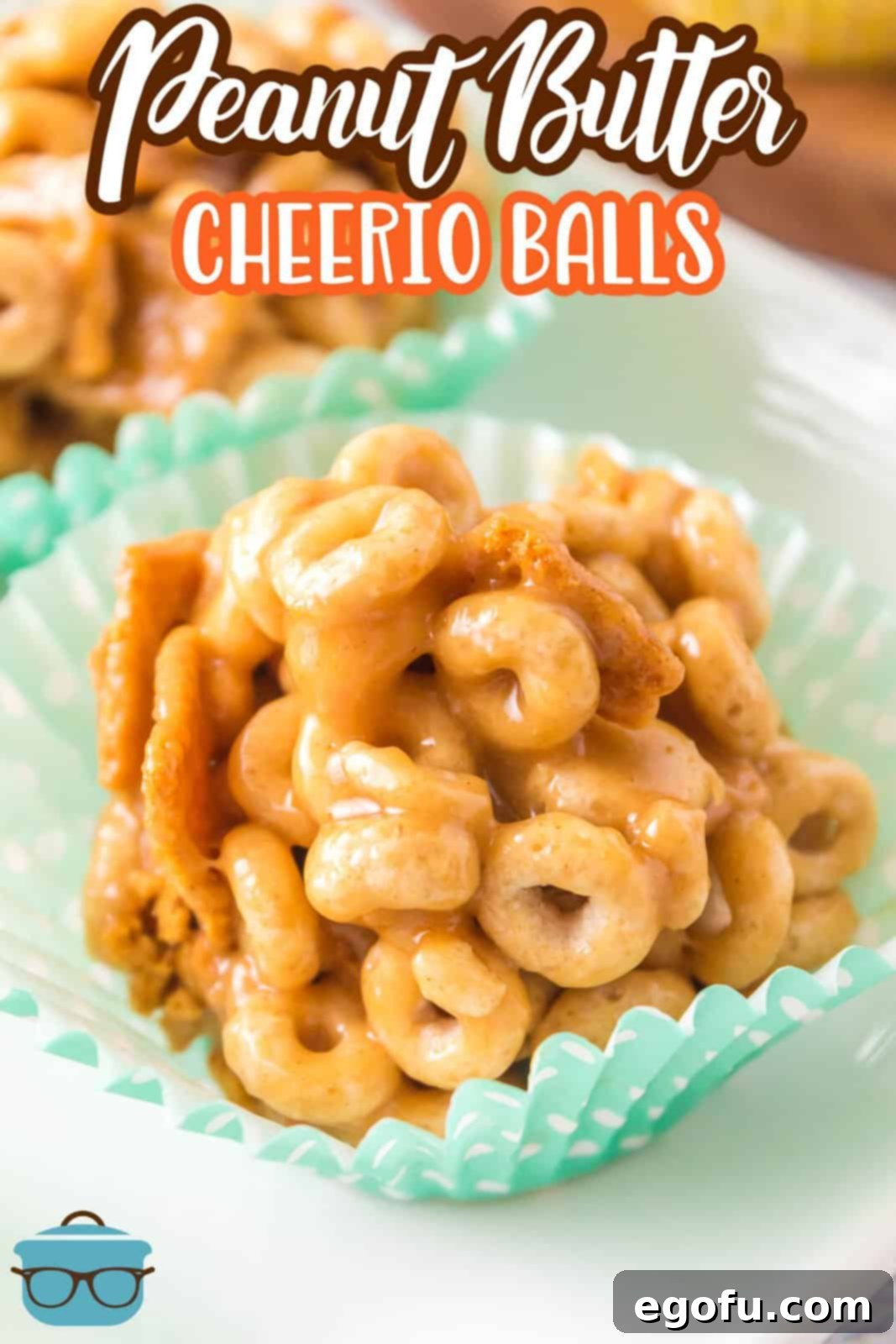 Close-up of Peanut Butter Cheerio Balls in paper liners, highlighting the crunchy cereal and gooey peanut butter mixture.