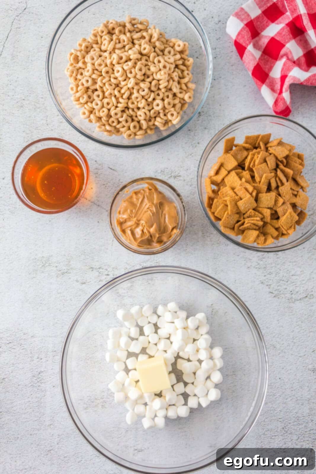 Butter pieces added to a bowl of mini marshmallows before melting in the microwave.