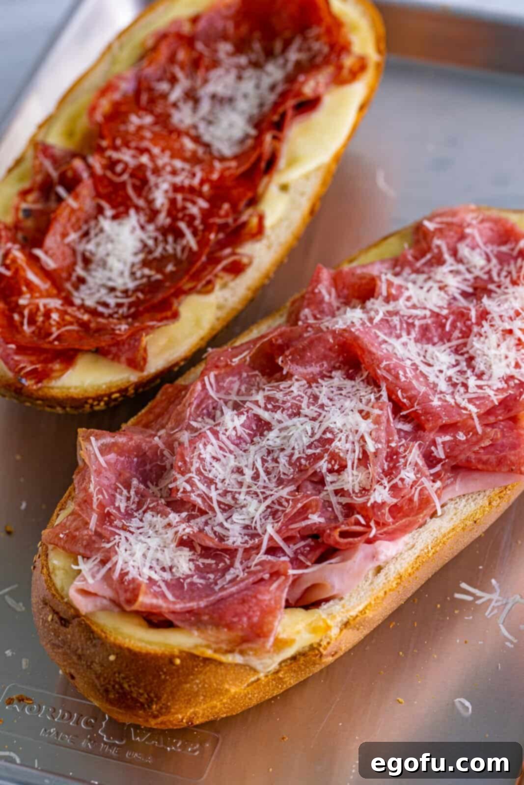 shredded Parmesan cheese added to both sides of the sub rolls.