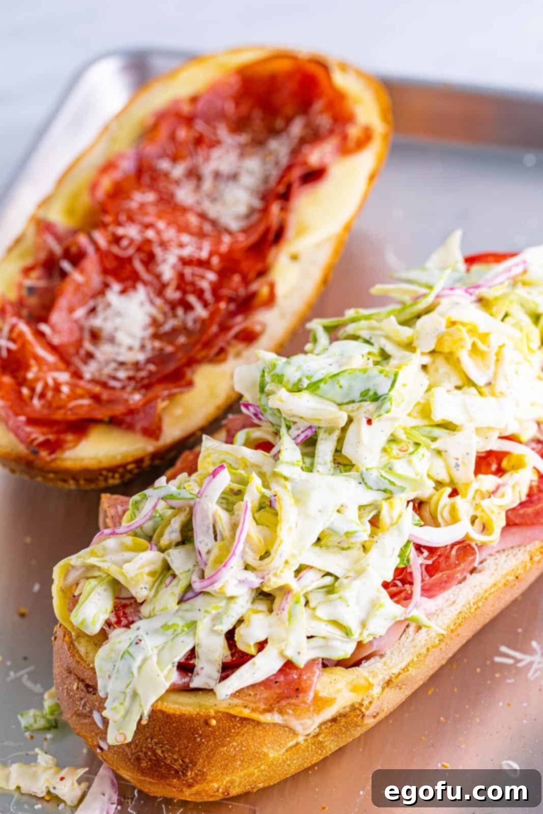 Grinder salad added on top of the deli meats on a sub roll.