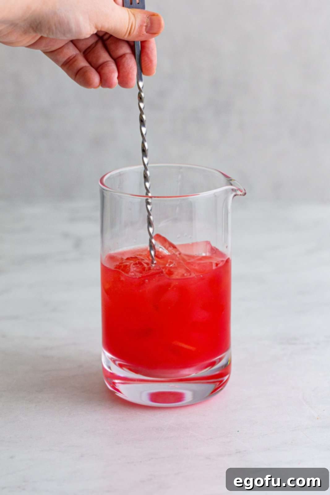 Coastal Affair Concoction 5 Cocktail ingredients added to drink mixer being stirred together, showing the initial mixing process.