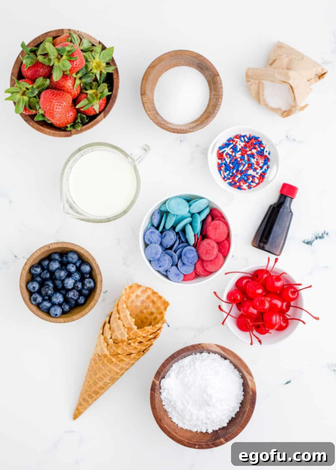 Ingredients needed: waffle cones, red melting candies, blue melting candies, strawberries, blueberries, granulated sugar, heavy cream, powdered sugar, cheesecake pudding mix, vanilla extract, maraschino cherries, red, white and blue sprinkles.
