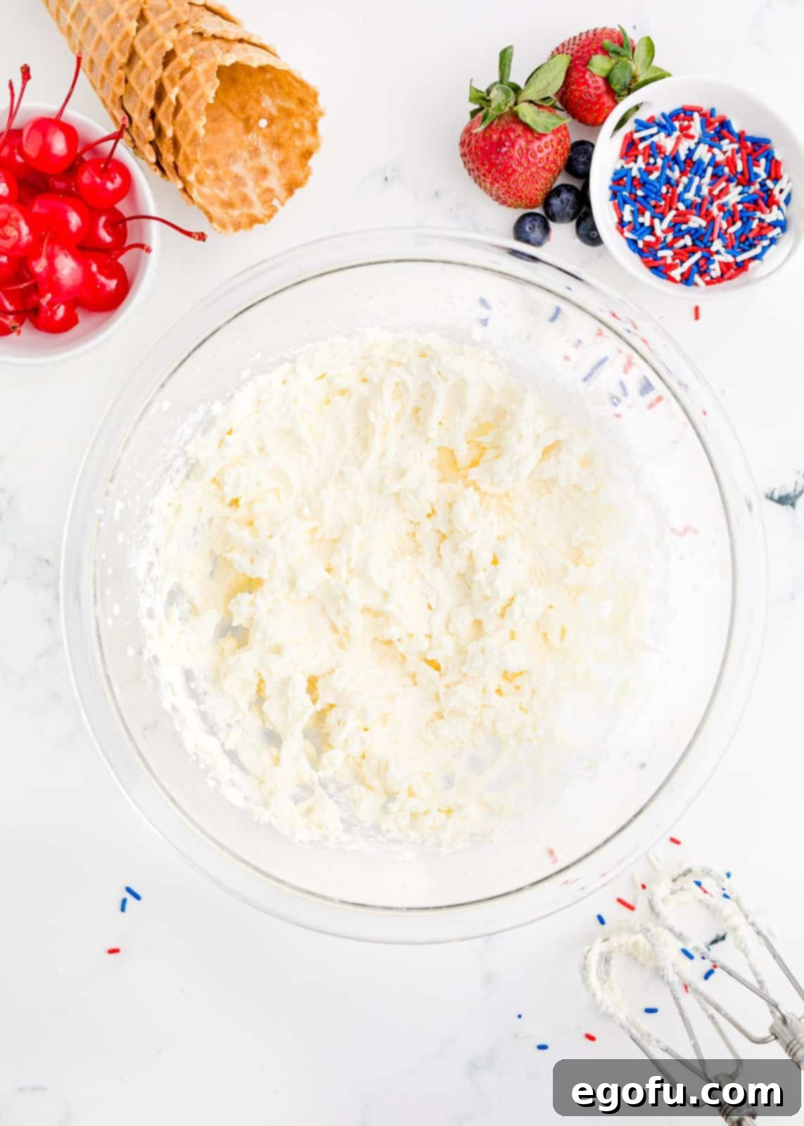 Beaten whipped cream in bowl.