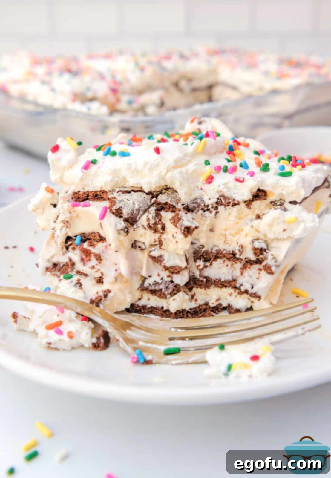 Slice of Ice Cream Sandwich Cake showing the layers on white plate.