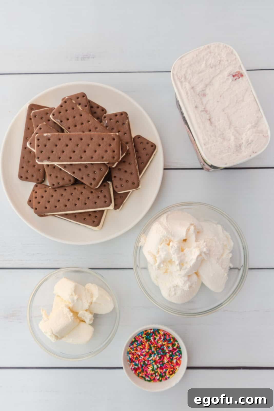 Ingredients needed: ice cream sandwiches, strawberry ice cream, frozen whipped topping, cream cheese and rainbow sprinkles.
