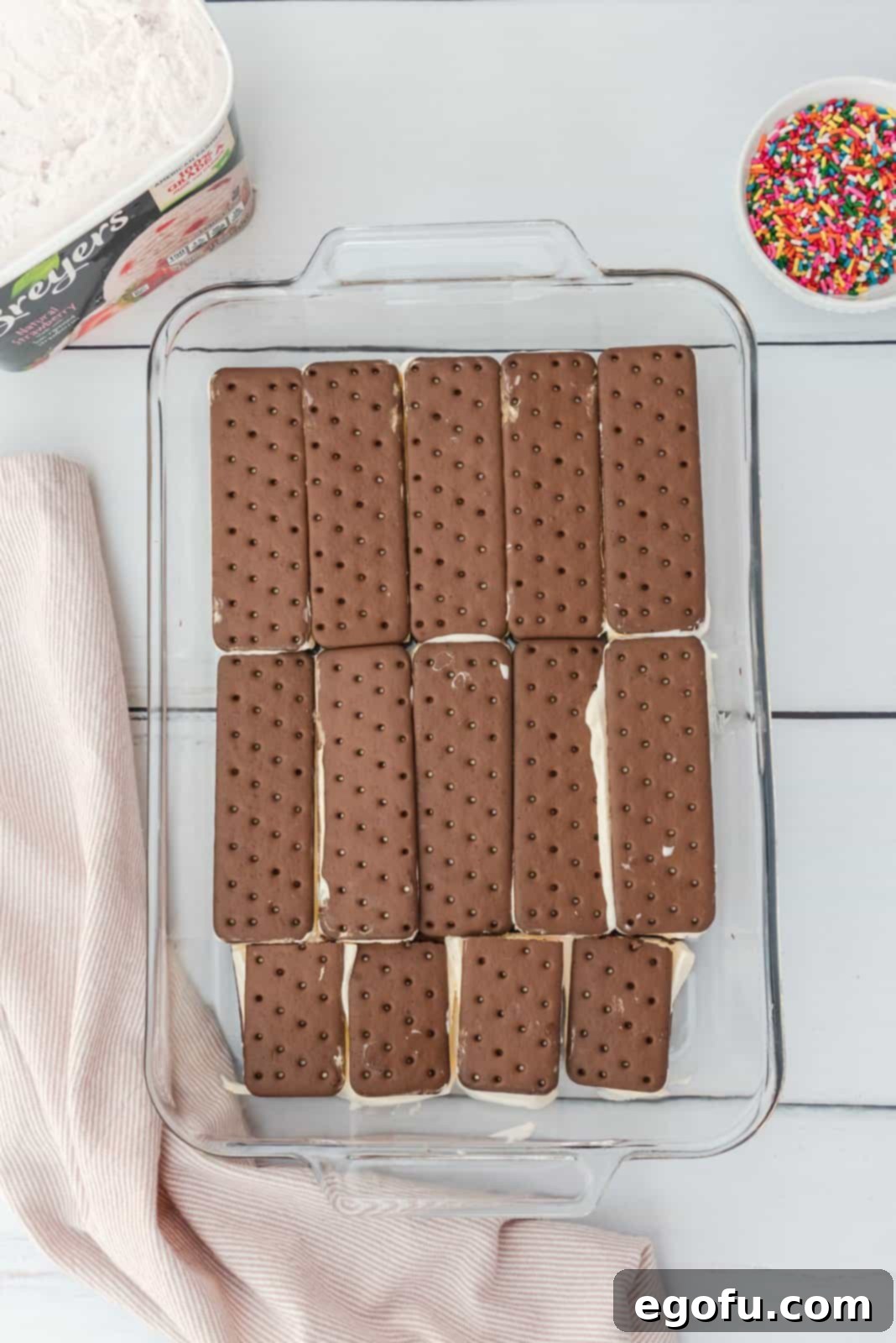 Ice cream sandwiches layered on bottom of baking dish.
