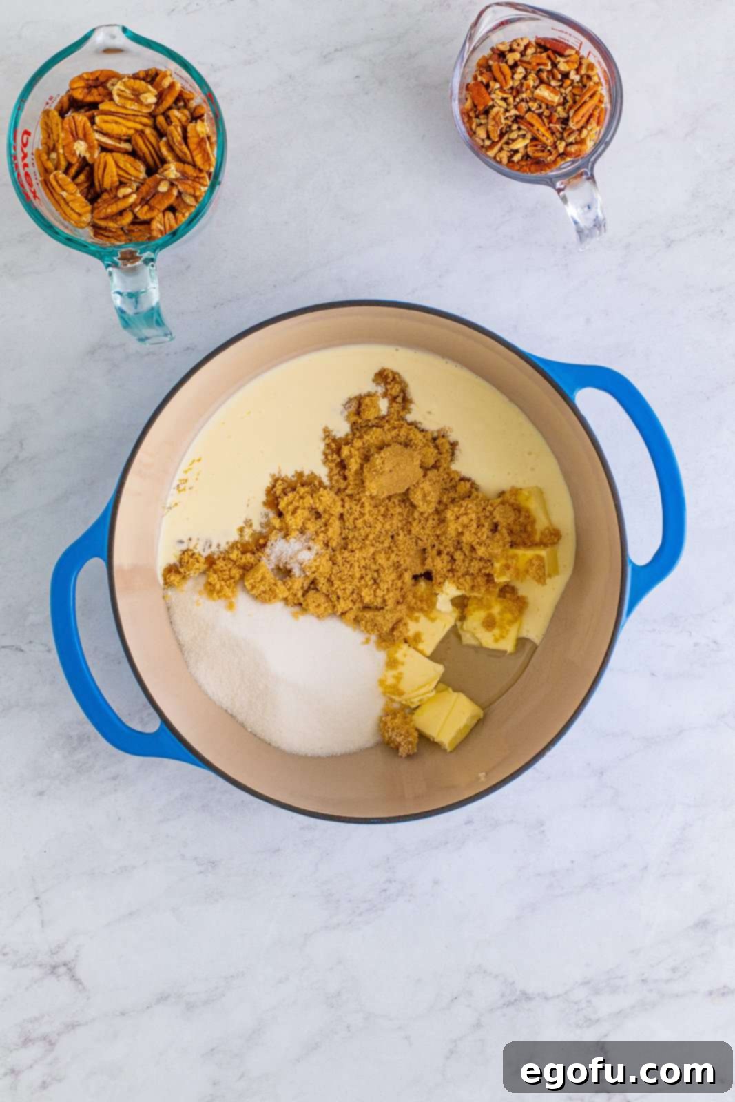 Decadent Southern Pecan Pralines 5 Butter, granulated sugar, brown sugar, heavy cream, corn syrup, and salt added to dutch oven.