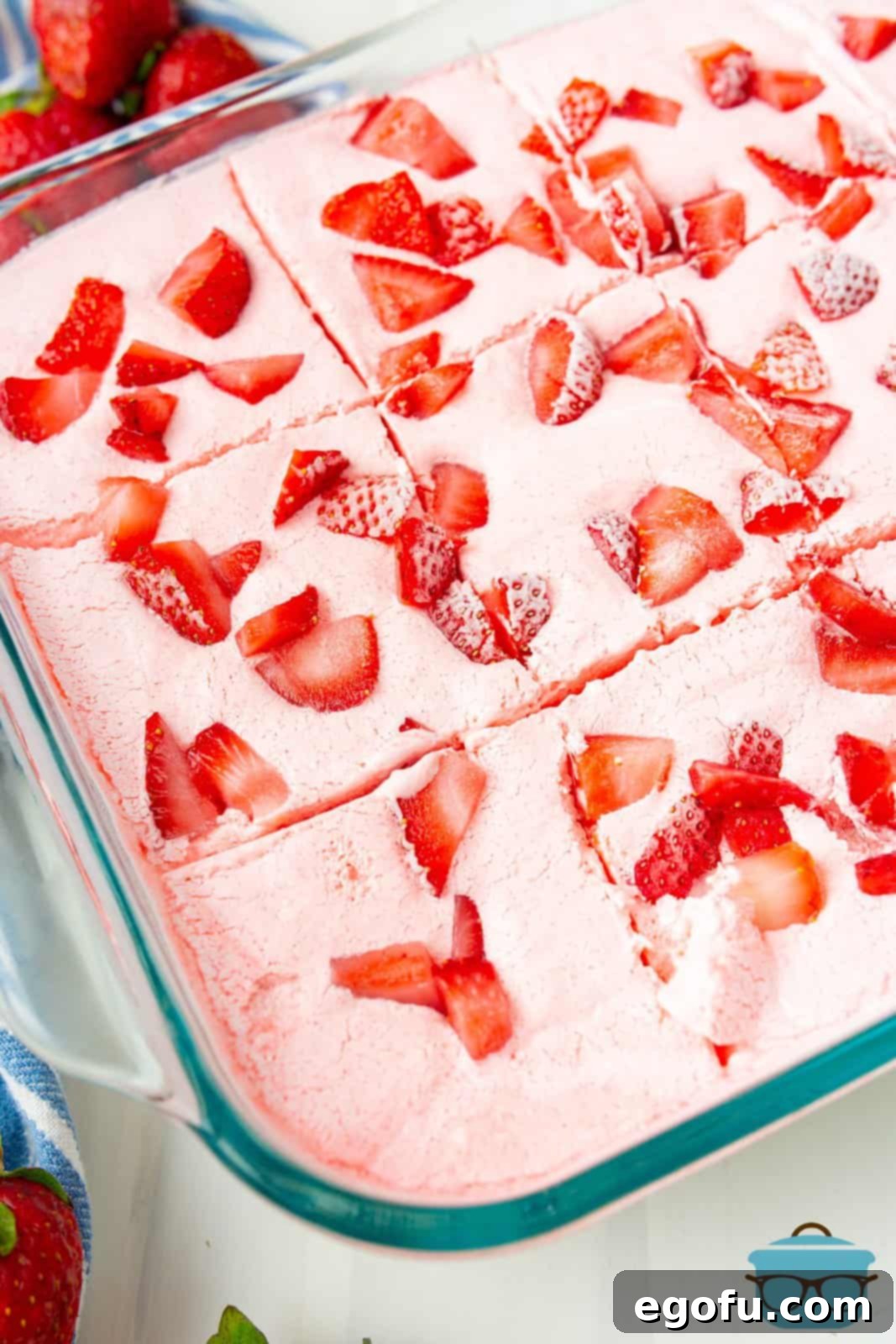 An overhead view of the finished Strawberry Icebox Cake, sliced neatly within the baking pan, showing the inviting layers.