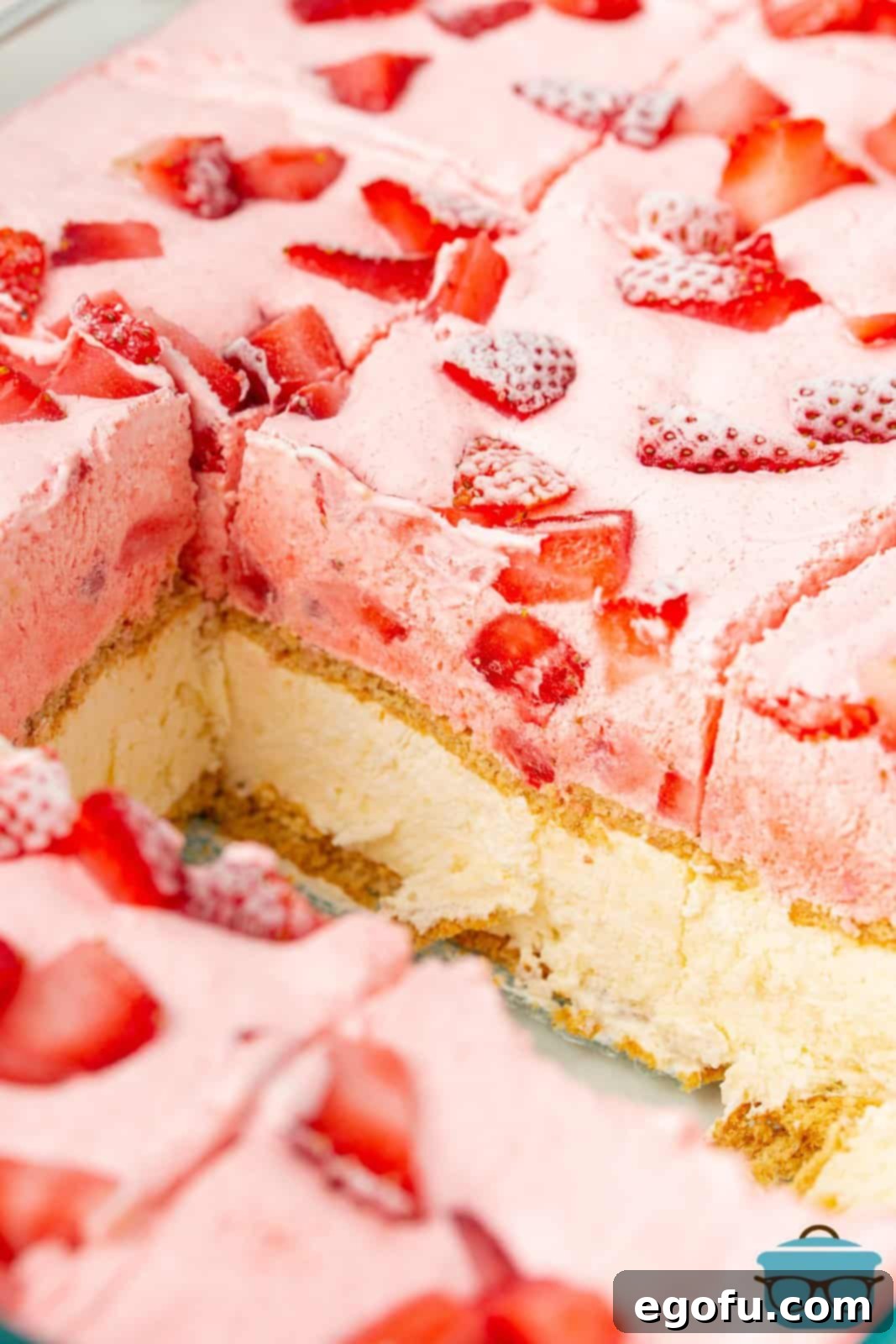 Individual cut slices of Strawberry Icebox Cake, removed from the pan, clearly displaying the beautiful graham cracker and creamy layers.