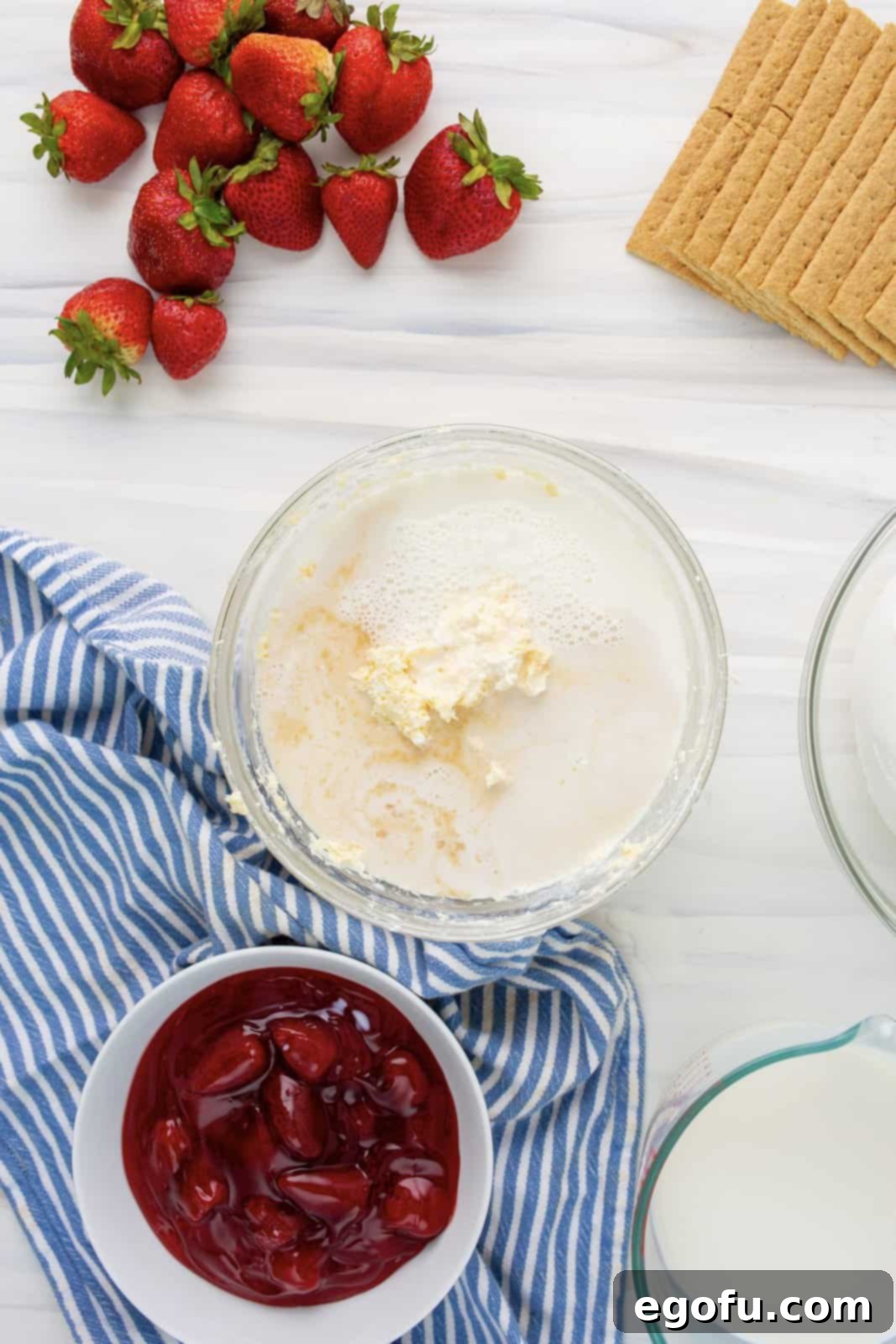 The initial mixture of cream cheese and cheesecake pudding in a bowl, before adding milk and vanilla.