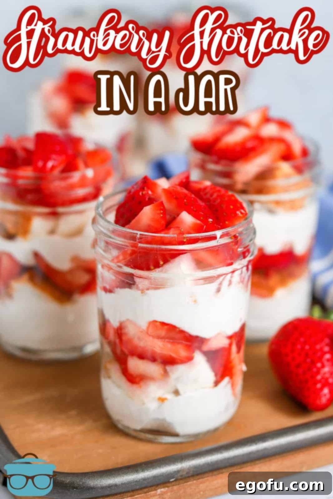 Strawberry Shortcake Jar Delights 3 Pinterest image of multiple Strawberry Shortcake in a Jar on wooden platter.