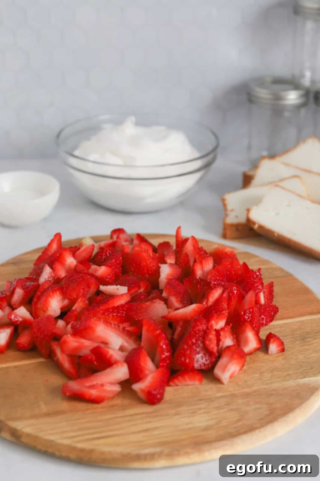 Strawberry Shortcake Jar Delights 5 Cut strawberries on cutting board.
