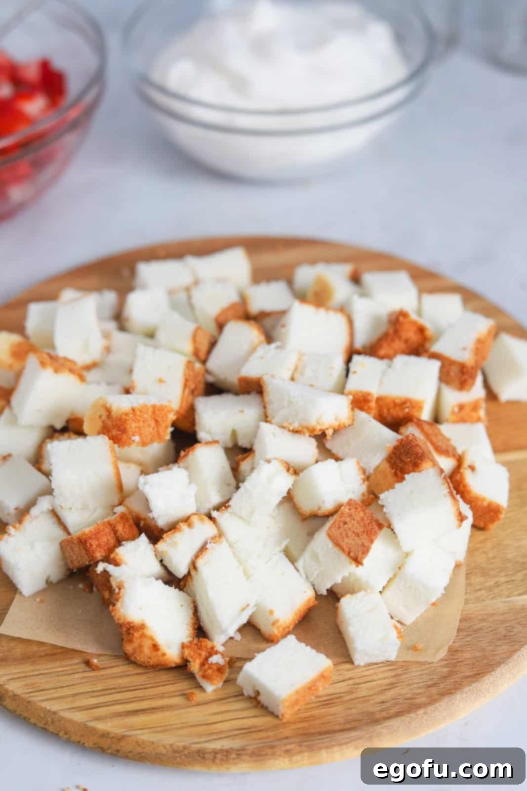 Strawberry Shortcake Jar Delights 7 Cut angel food cake on cutting board.