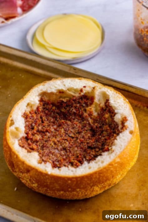 New Orleans' Signature Stack 17 Olive spread spread on bottom of hollowed out bread.