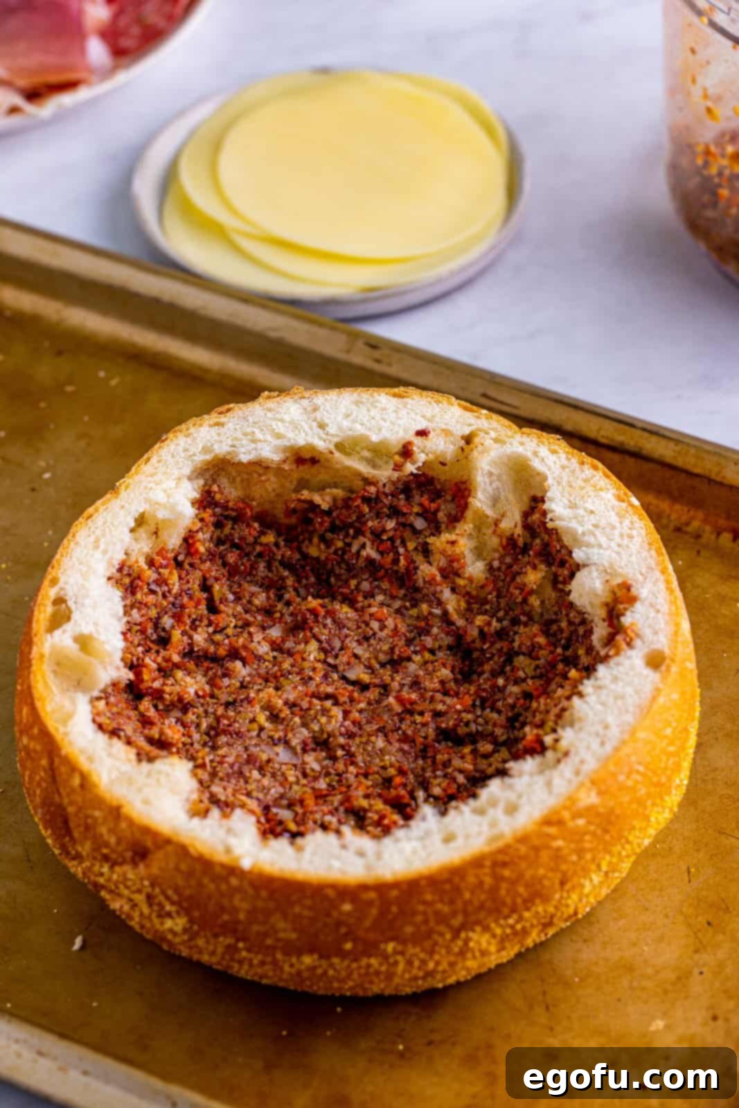 New Orleans' Signature Stack 7 Olive spread spread on bottom of hollowed out bread.