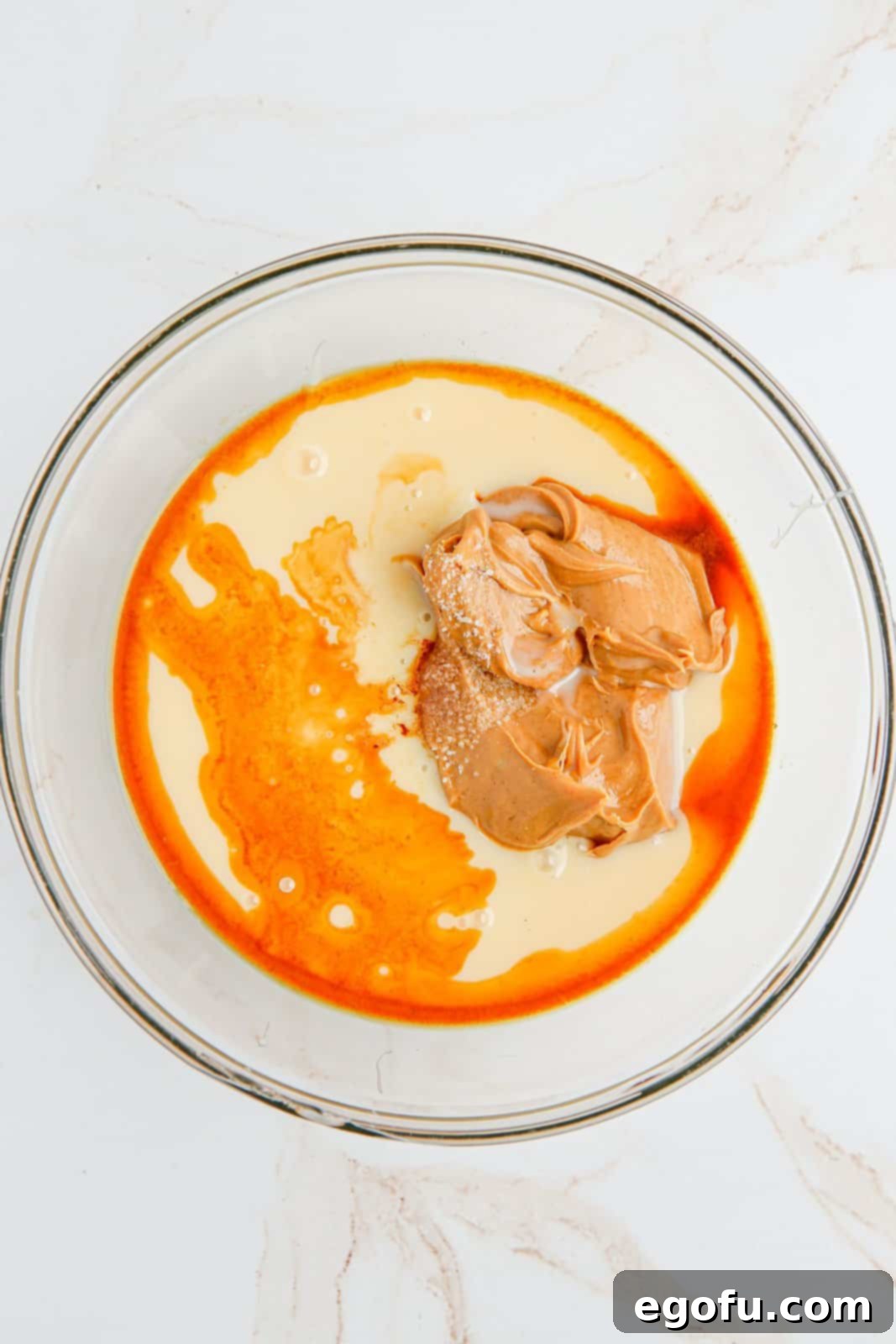 Sweetened condensed milk, vanilla, salt and peanut butter added to bowl.