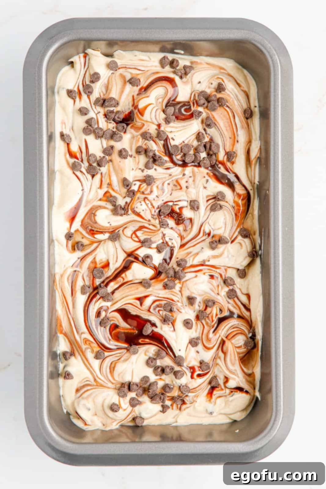 Swirled ice cream in pan waiting to be frozen.