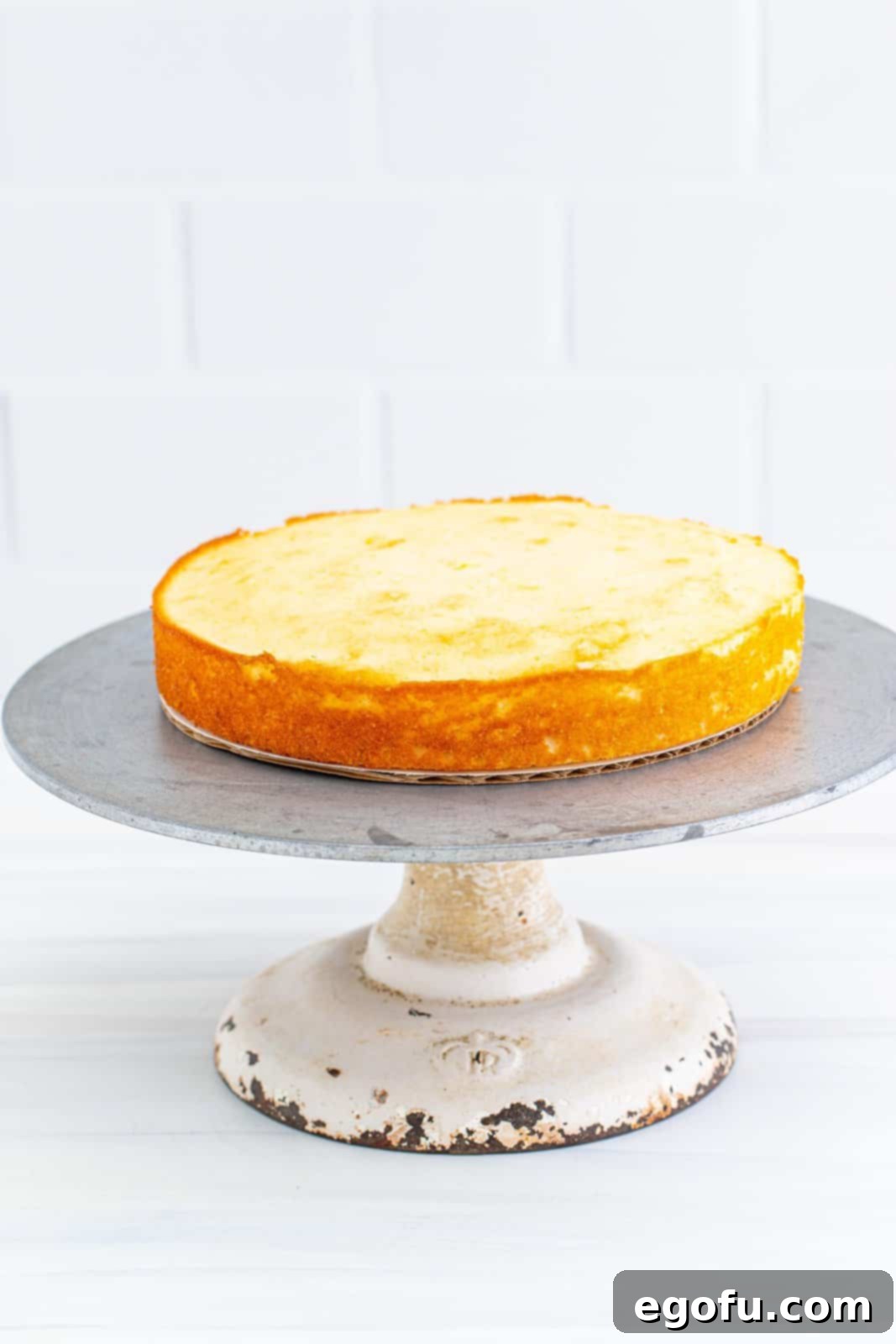 Zesty Lemon Dream Cake 14 One cake layer placed on cake stand.