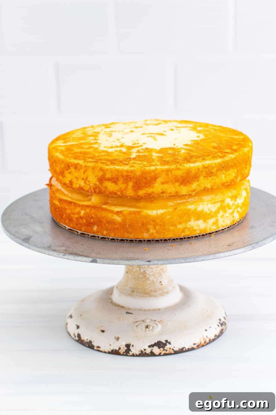 Zesty Lemon Dream Cake 16 Second cake layer added to the top of lemon curd filling.