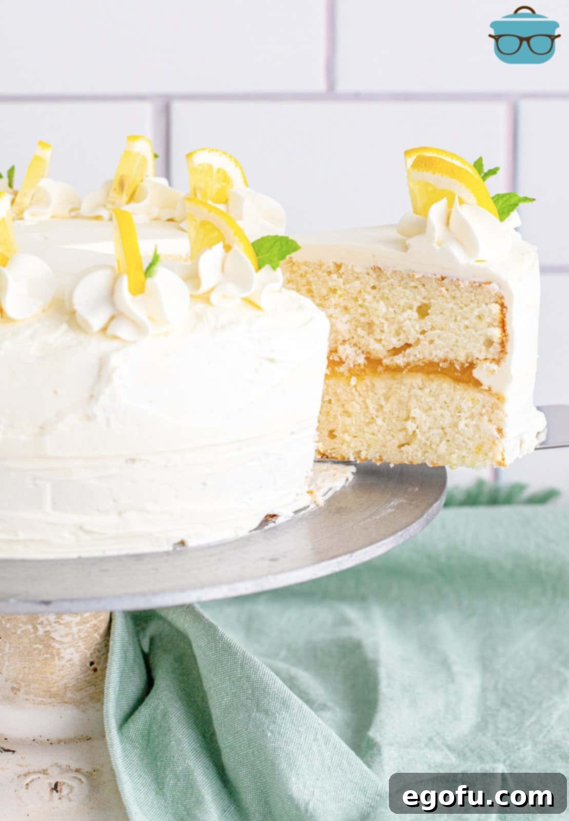 Zesty Lemon Dream Cake 20 Slice of Lemon Layer Cake being removed from whole cake.