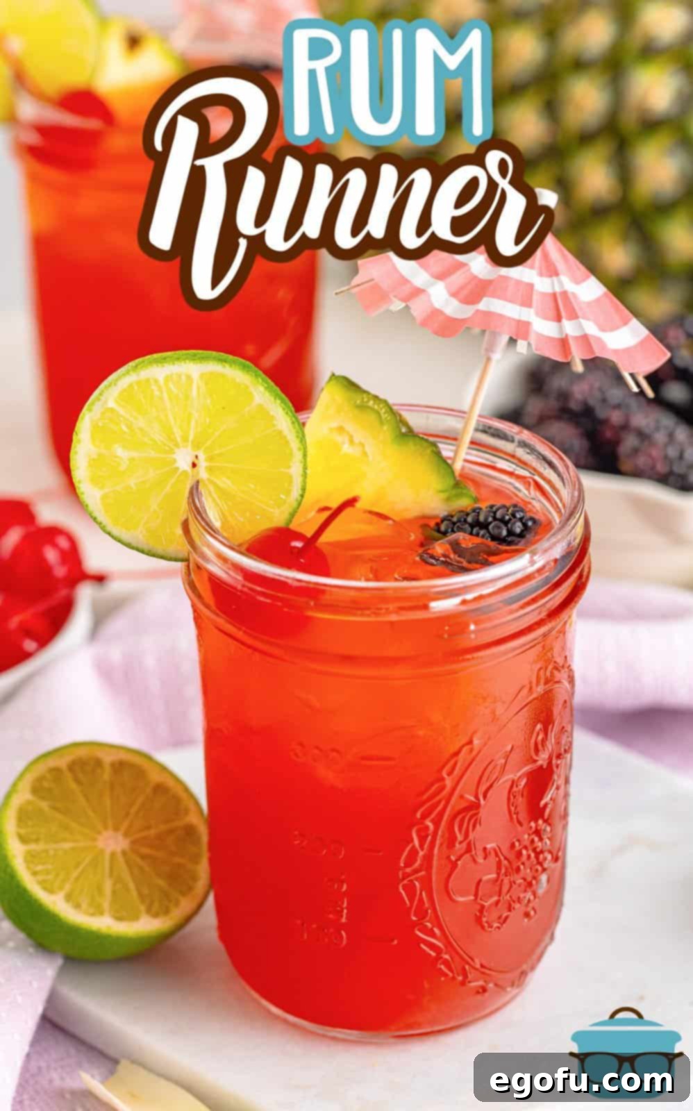 An overhead view of the Rum Runner Cocktail, garnished with lime and berries, showcasing its vibrant colors and inviting presentation.