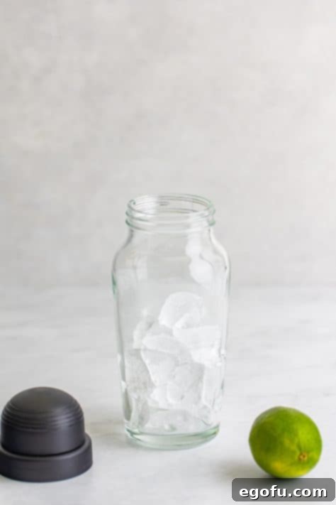 Ice added to the cocktail shaker.