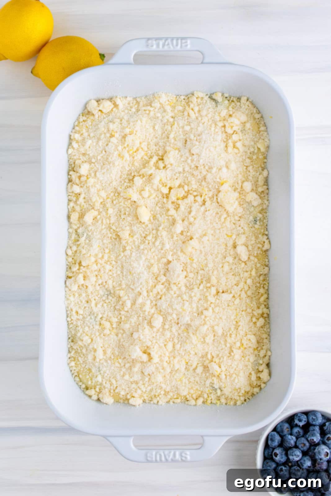 Half of crumble mixture sprinkled over cake batter.