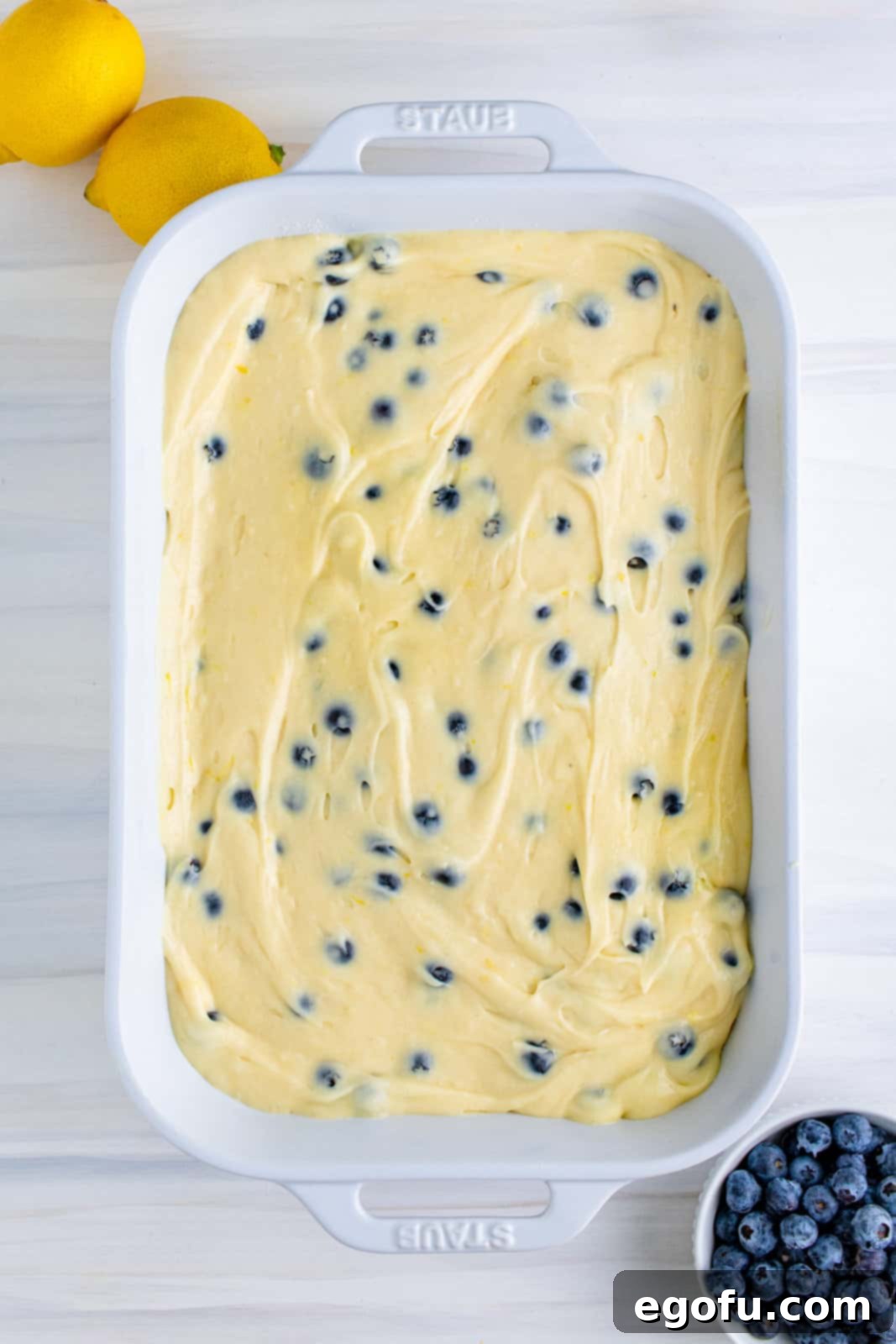 Remaining cake batter spread over crumble mixture.