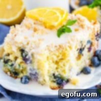 Close up square image of slice of Lemon Blueberry Coffee Cake with bite taken out of slice.