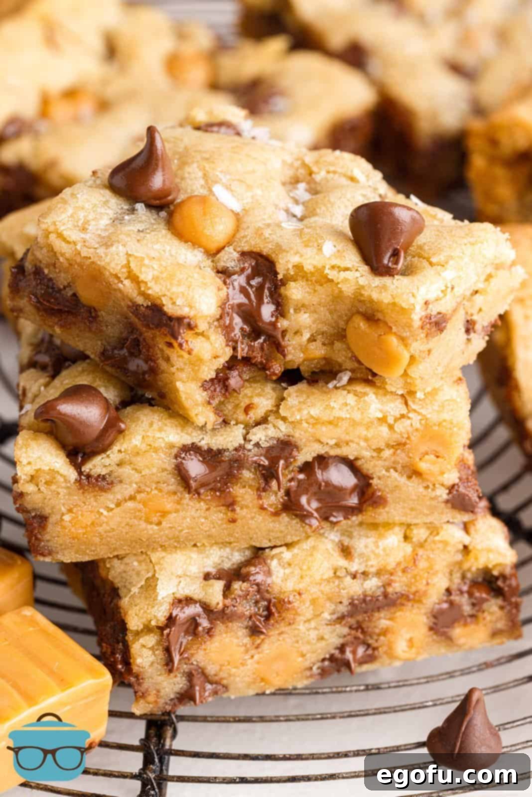 Sweet and Salty Caramel Chocolate Chip Bars 2 Stacked Salted Caramel Chocolate Chip Cookie Bars with bite taken out of top one.