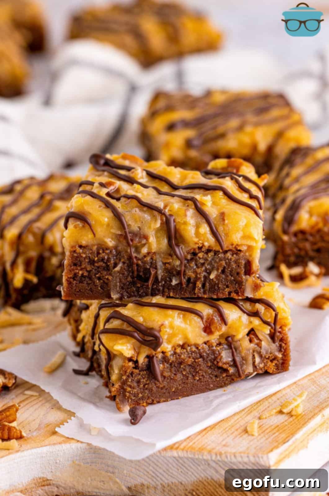 Two rich German Chocolate Brownies, stacked on top of each other, showcasing their fudgy texture and creamy coconut pecan frosting.