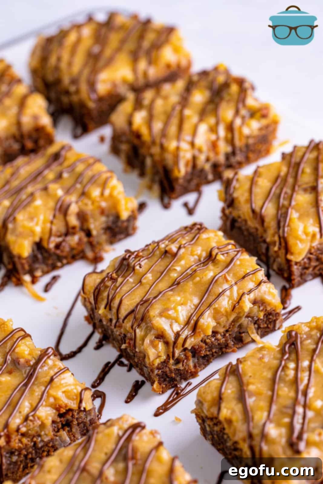 Perfectly sliced German Chocolate Brownies, beautifully drizzled with melted chocolate, arranged on parchment paper, ready to be enjoyed.