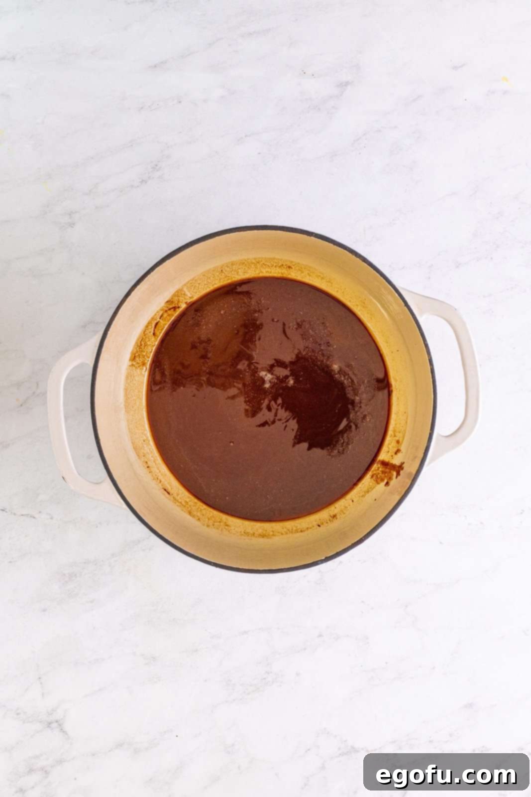 Smooth, melted chocolate and butter mixture in a Dutch oven after stirring.