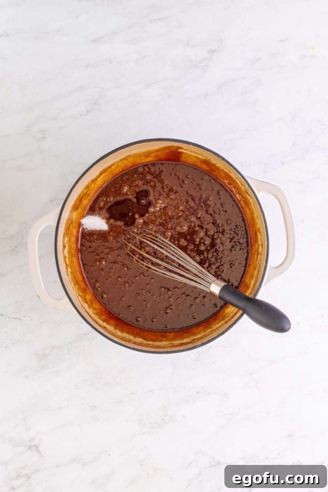 Vanilla extract and salt added to the chocolate-egg mixture, ready for final whisking.