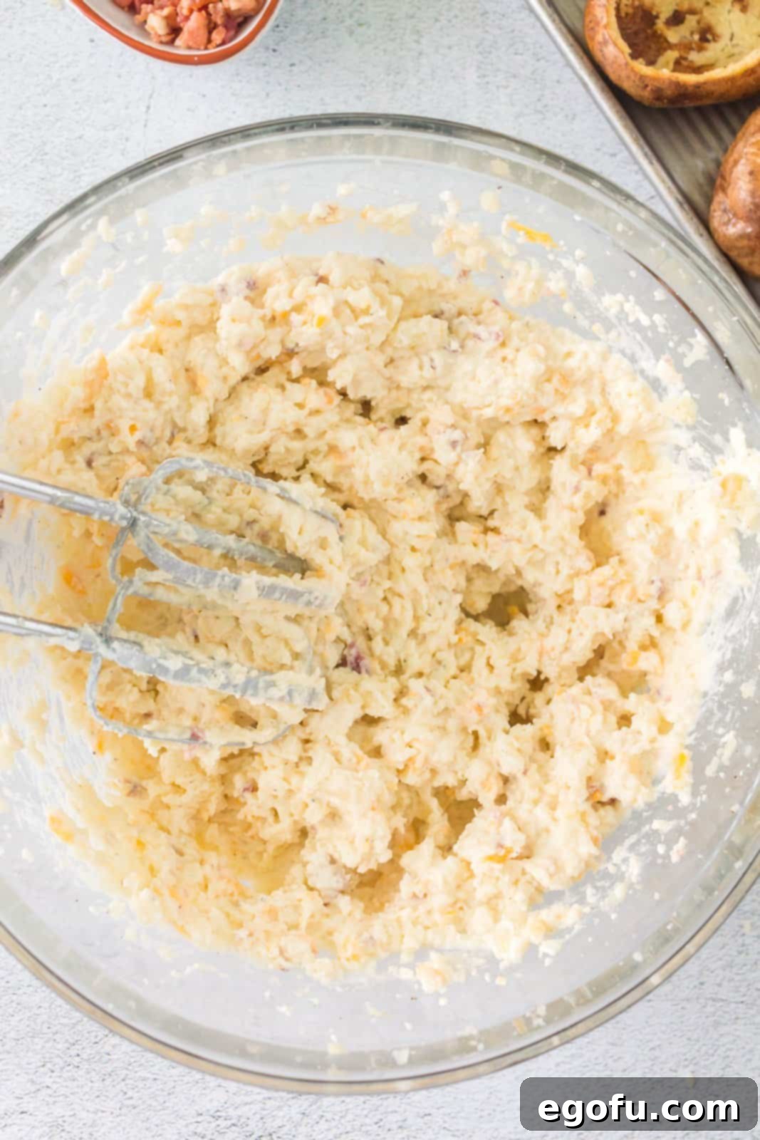 Fully blended potato mixture with all filling ingredients, showing a smooth, creamy texture in the mixing bowl.