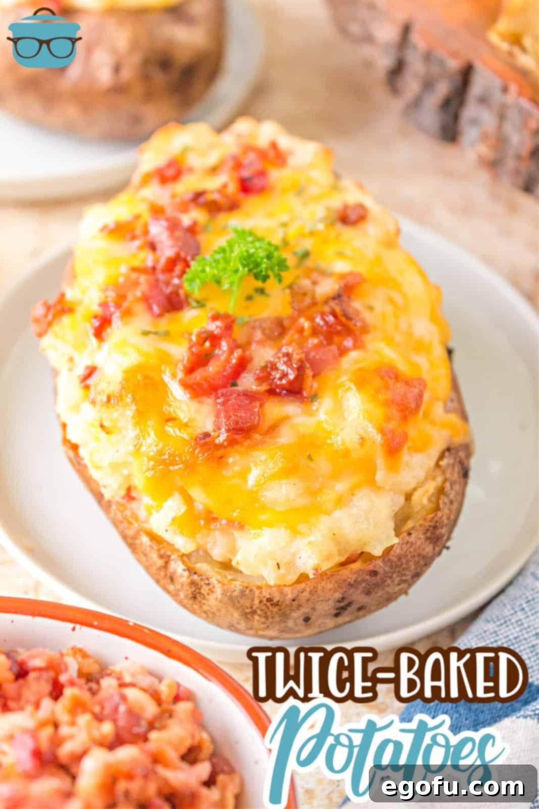 Close-up Pinterest image of one of the Grilled Twice Baked Potatoes on a white plate, showcasing the melted cheese and crispy bacon topping.