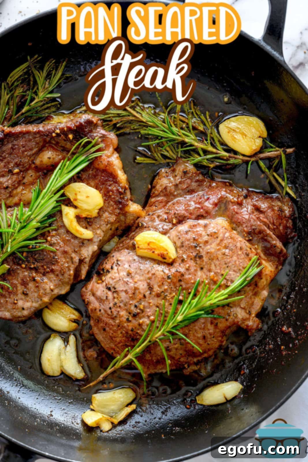Pinterest image overhead of finished Pan Seared Steak in skillet, perfectly crusted and ready to rest.